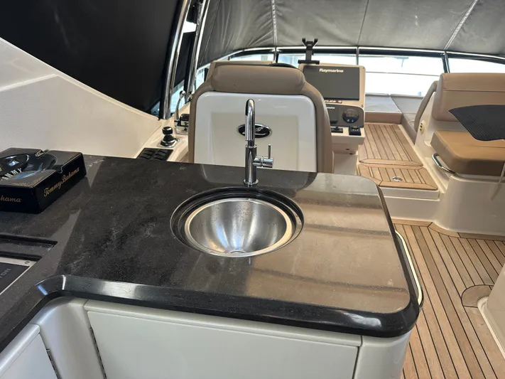 Working Late Yacht Photos Pics Luxurious 2016 Sea Ray L590 Fly yacht interior with sleek kitchenette and modern amenities.