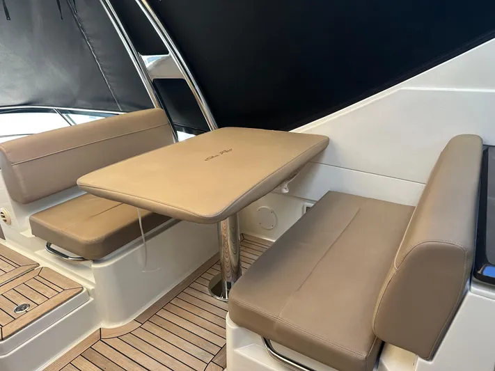 Working Late Yacht Photos Pics 2016 Sea Ray L590 Fly yacht interior with beige seating and table.