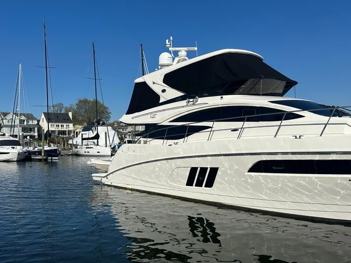Working Late Yacht Photos Pics 2016 Sea Ray L590 Fly yacht docked in a marina under clear blue skies.
