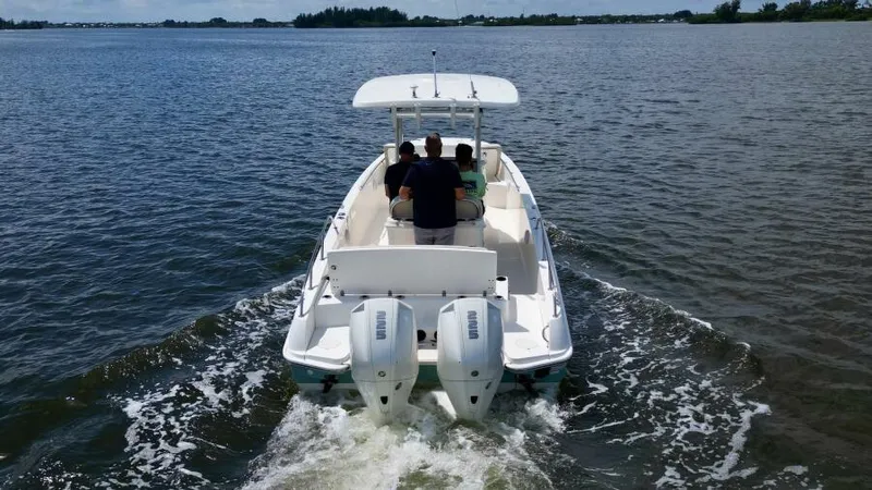  Yacht Photos Pics 2019 Boston Whaler DAUNTLESS boat cruising on open water with two passengers.