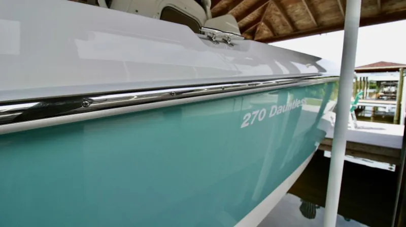  Yacht Photos Pics 2019 Boston Whaler DAUNTLESS boat side view in dock, showcasing sleek design.