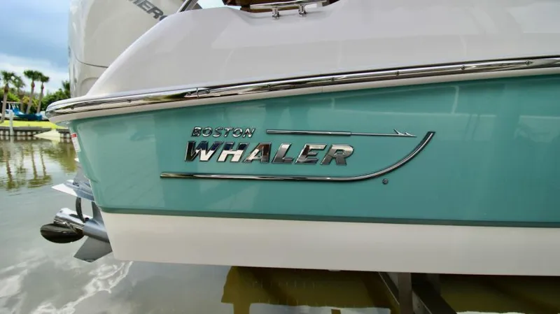  Yacht Photos Pics 2019 Boston Whaler DAUNTLESS boat, turquoise hull, docked on calm water.