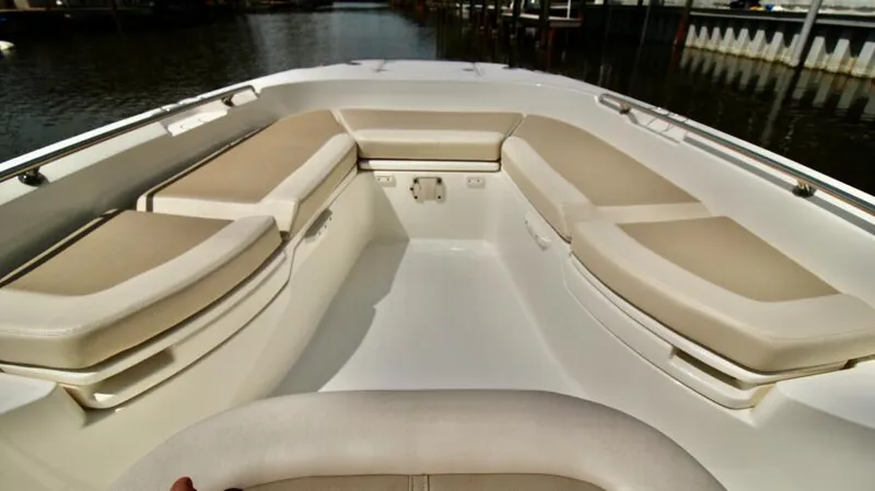  Yacht Photos Pics 2019 Boston Whaler DAUNTLESS boat interior with cushioned seating and sleek design.