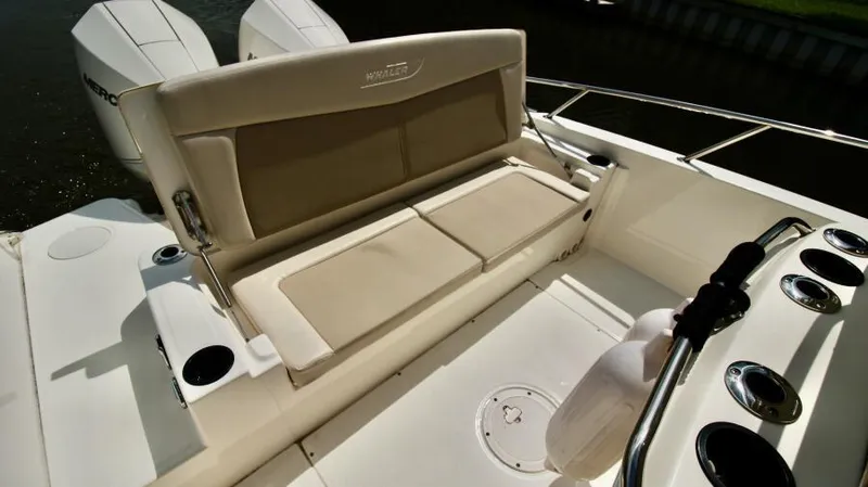  Yacht Photos Pics 2019 Boston Whaler DAUNTLESS boat interior with cushioned seating and dual engines.