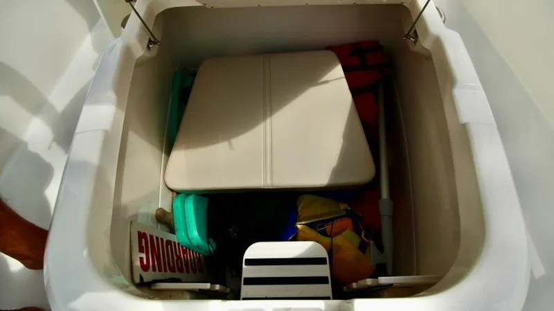  Yacht Photos Pics Storage compartment in 2019 Boston Whaler DAUNTLESS boat, containing various boating accessories.