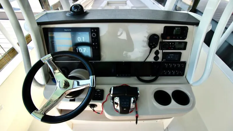  Yacht Photos Pics 2019 Boston Whaler DAUNTLESS boat dashboard with steering wheel and navigation controls.
