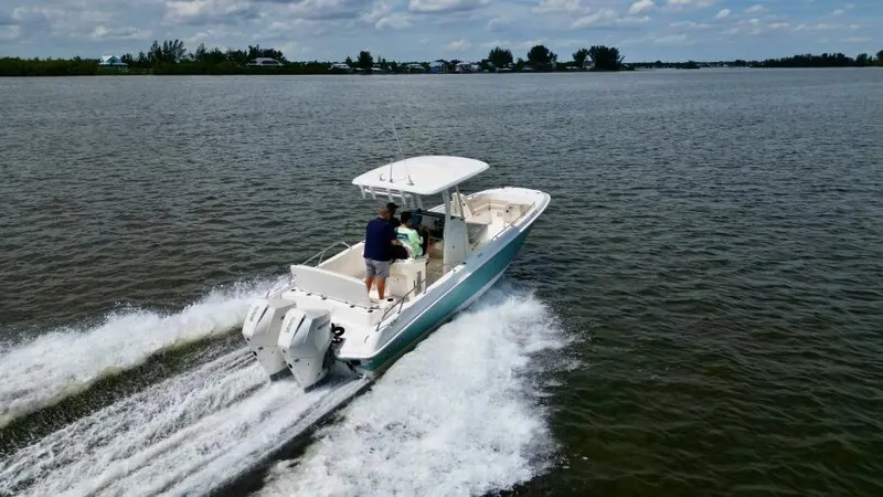  Yacht Photos Pics 2019 Boston Whaler DAUNTLESS cruising on open water, rear view.