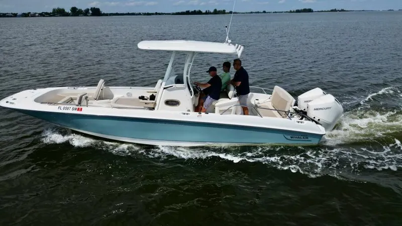  Yacht Photos Pics 2019 Boston Whaler DAUNTLESS boat cruising on open water with two people onboard.