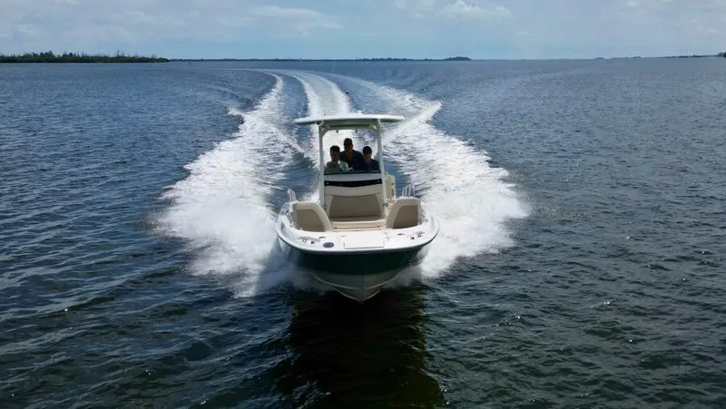  Yacht Photos Pics 2019 Boston Whaler DAUNTLESS cruising on open water, creating a wake.