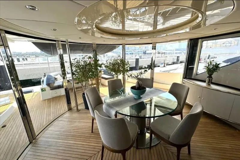  Yacht Photos Pics Luxurious interior of 2003 Azimut 98 Leonardo yacht with elegant dining area and panoramic views.