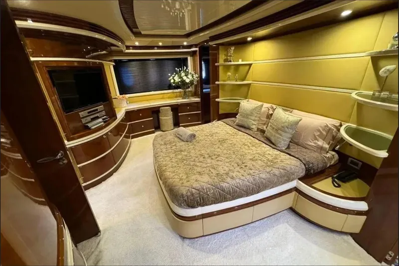  Yacht Photos Pics Luxurious bedroom interior of 2003 Azimut 98 Leonardo yacht with elegant decor and modern amenities.