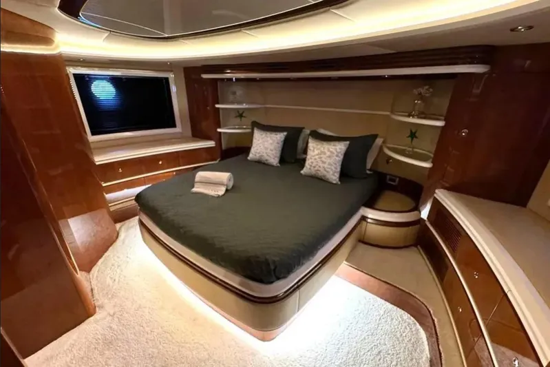  Yacht Photos Pics Luxurious bedroom interior of 2003 Azimut 98 Leonardo yacht with elegant wood finishes.