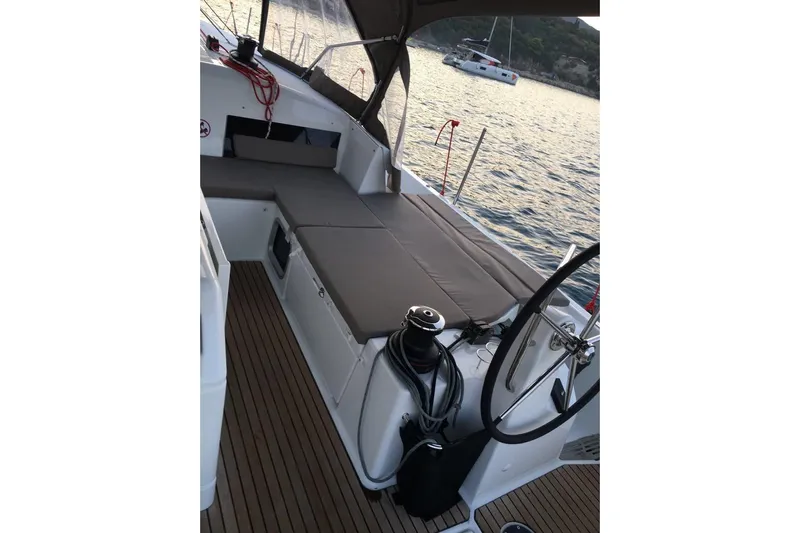  Yacht Photos Pics 2019 Jeanneau Sun Odyssey 490 sailboat cockpit with seating, steering wheel, and ocean view.