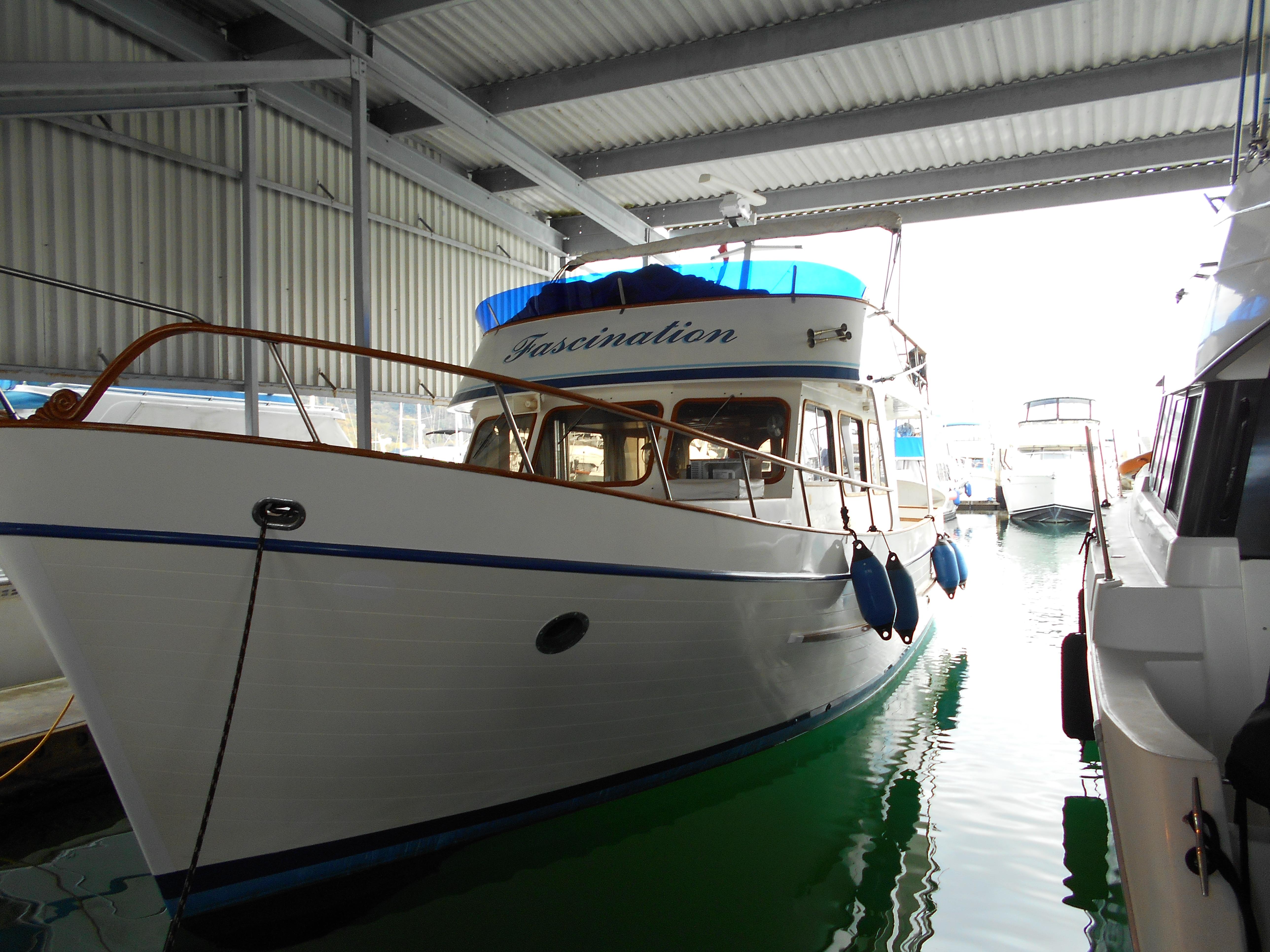 1977 Davis 42' boat docked in a covered marina.