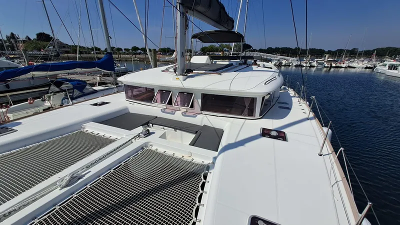  Yacht Photos Pics 2012 Lagoon 450 F catamaran docked in a marina under clear blue skies.