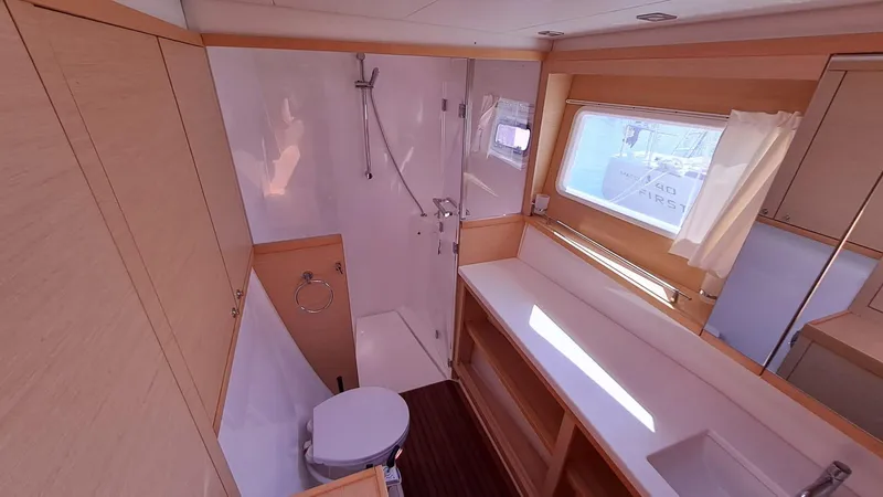  Yacht Photos Pics Bathroom interior of 2012 Lagoon 450 F yacht, featuring shower, toilet, and window.