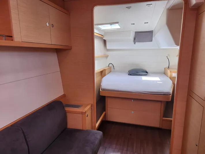  Yacht Photos Pics Interior of 2012 Lagoon 450 F yacht with cozy bedroom and wooden furnishings.