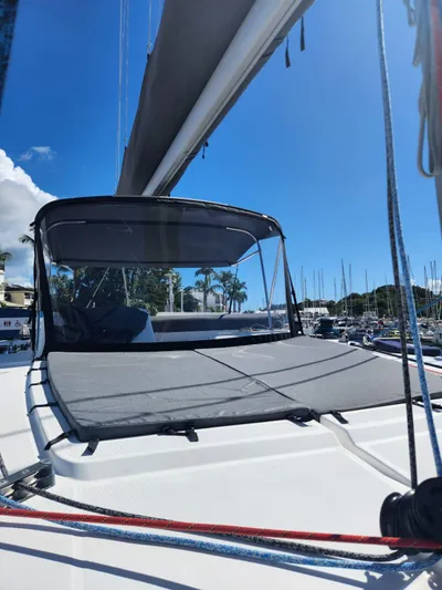  Yacht Photos Pics 2012 Lagoon 450 F catamaran with sun deck, docked in a marina under clear blue skies.