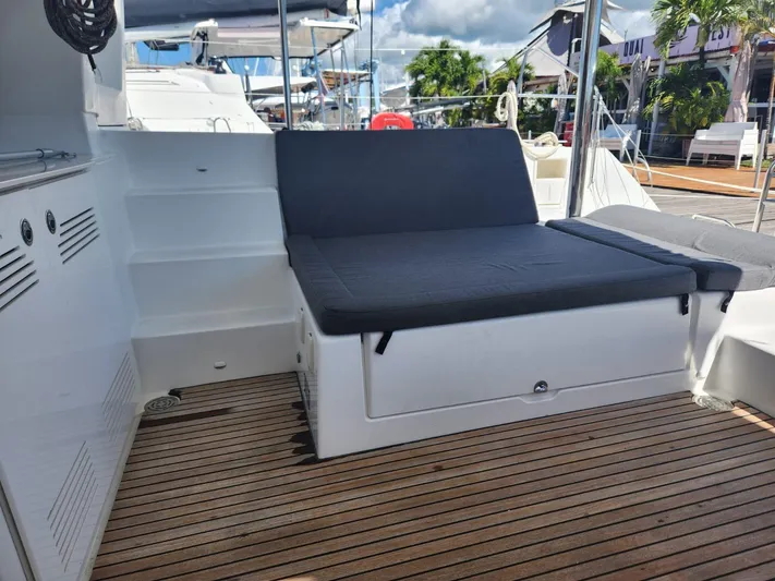  Yacht Photos Pics Lagoon 450 F 2012 yacht with cushioned seating and wooden deck.
