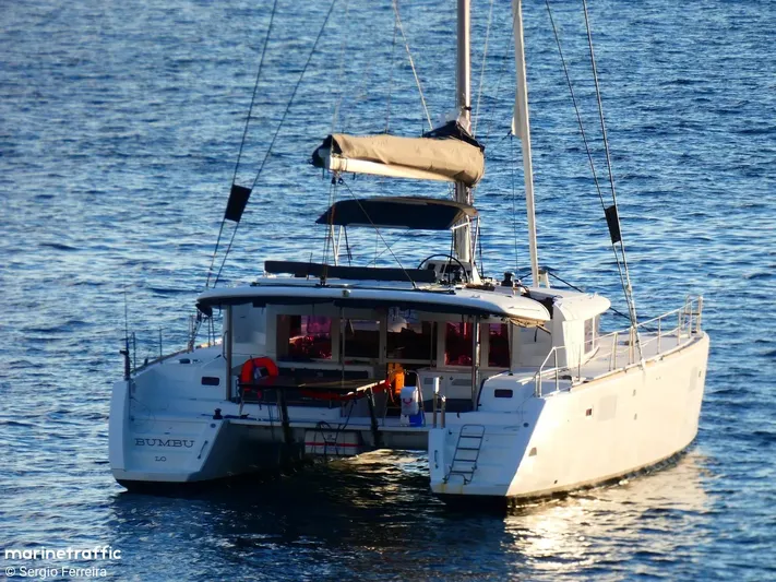  Yacht Photos Pics 2012 Lagoon 450 F catamaran sailing on calm blue waters.