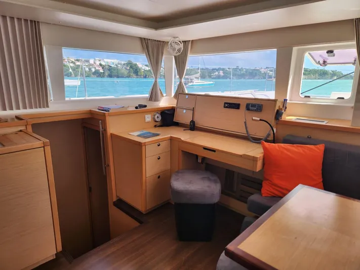  Yacht Photos Pics Interior of 2012 Lagoon 450 F catamaran with desk, seating, and ocean view.