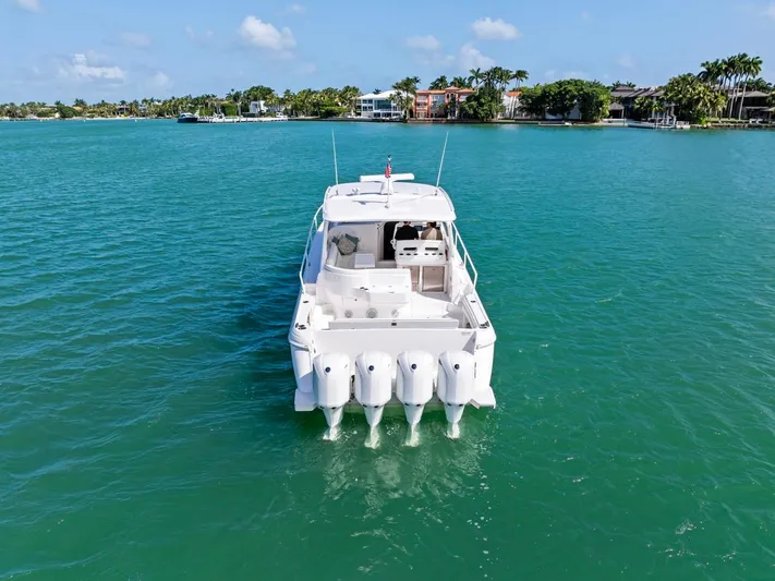  Yacht Photos Pics 2018 Intrepid 475 Sport Yacht on turquoise water, rear view with four engines.