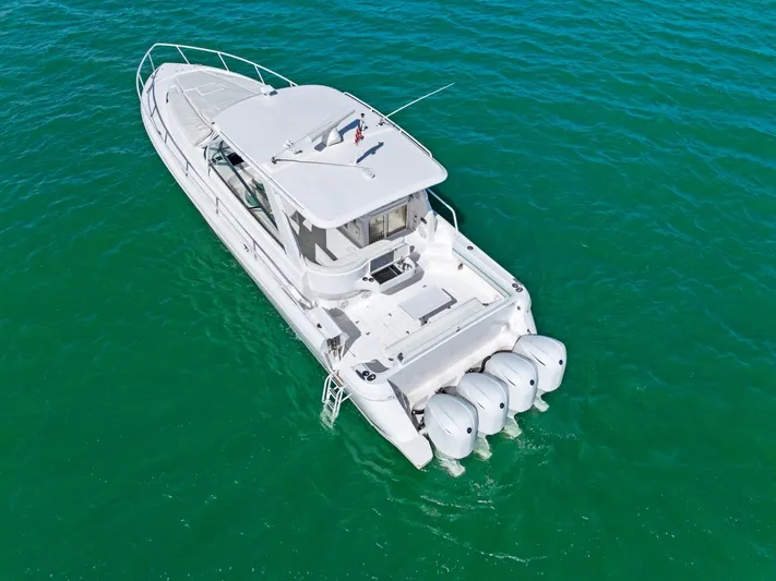 Yacht Photos Pics 2018 Intrepid 475 Sport Yacht on clear turquoise water, aerial view.