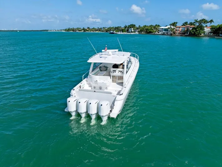  Yacht Photos Pics 2018 Intrepid 475 Sport Yacht cruising on turquoise waters under a clear sky.