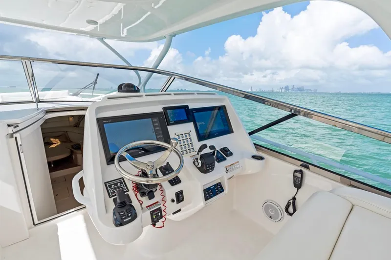  Yacht Photos Pics 2018 Intrepid 475 Sport Yacht helm with advanced navigation systems, overlooking ocean and skyline.