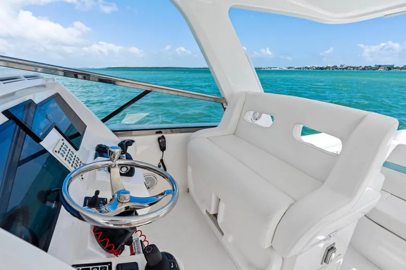  Yacht Photos Pics 2018 Intrepid 475 Sport Yacht helm with ocean view, featuring sleek design and modern controls.