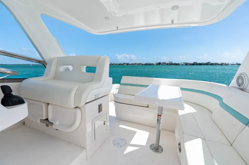  Yacht Photos Pics 2018 Intrepid 475 Sport Yacht interior with white seating and ocean view.