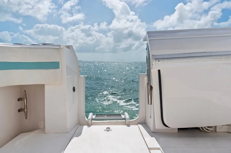  Yacht Photos Pics 2018 Intrepid 475 Sport Yacht, rear view, overlooking ocean under cloudy sky.