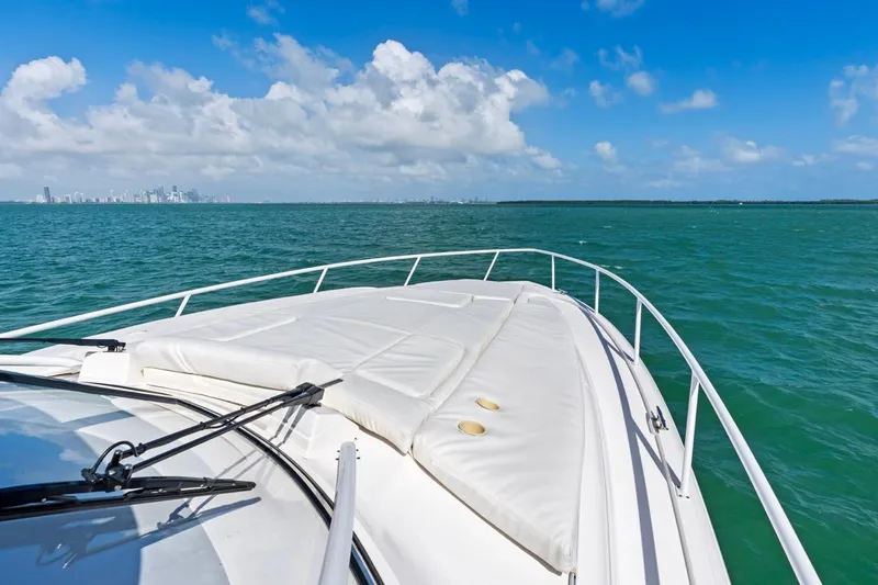 Yacht Photos Pics 2018 Intrepid 475 Sport Yacht cruising on turquoise waters under a clear blue sky.