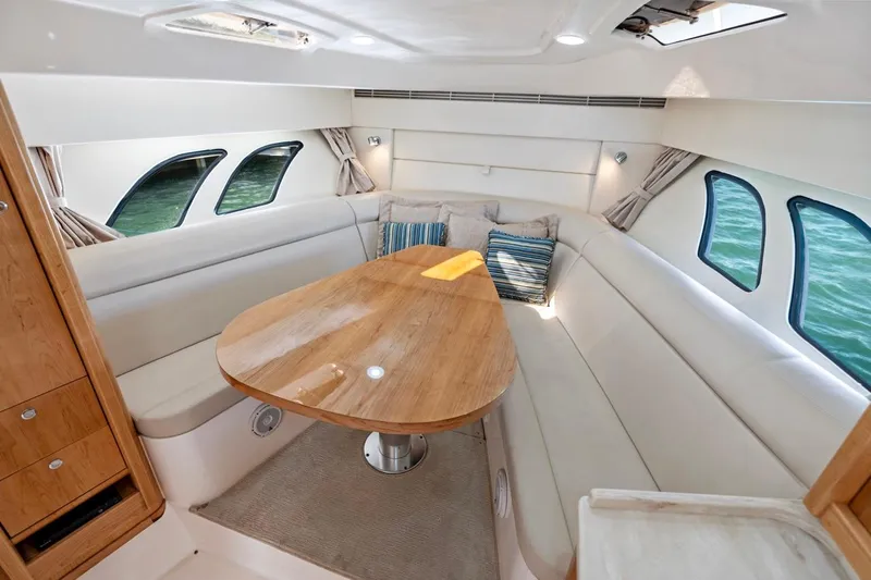  Yacht Photos Pics Interior of 2018 Intrepid 475 Sport Yacht with elegant seating and wooden table.