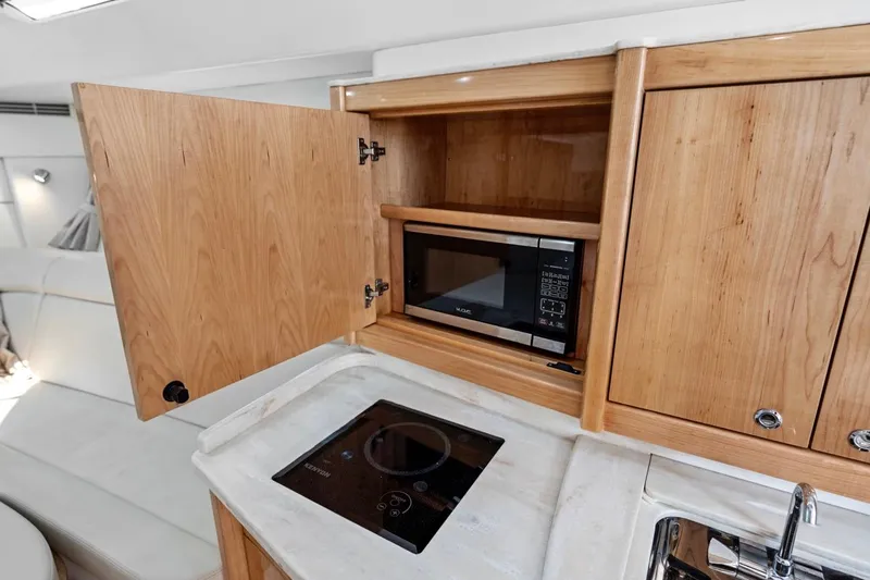  Yacht Photos Pics 2018 Intrepid 475 Sport Yacht kitchen with microwave and stovetop.