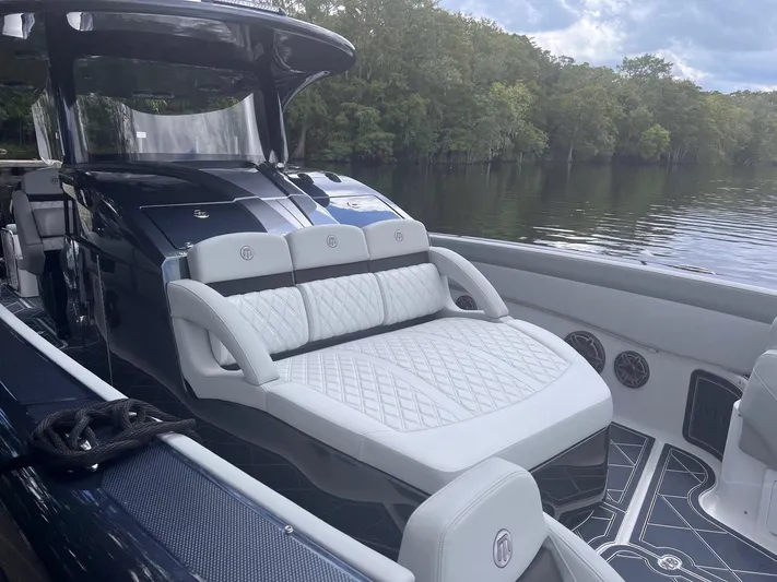  Yacht Photos Pics 2024 Mystic Powerboats M3800 luxury seating with scenic water backdrop.