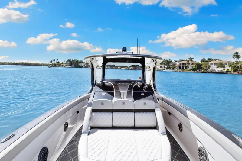  Yacht Photos Pics 2024 Mystic Powerboats M3800 cruising on a sunny, tropical waterway.