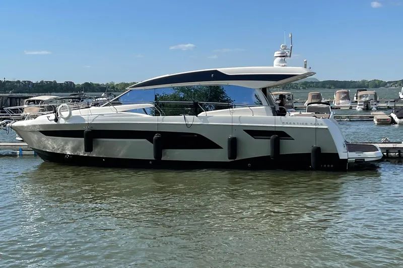  Yacht Photos Pics 2018 Prestige 520 yacht docked at a marina on a sunny day.