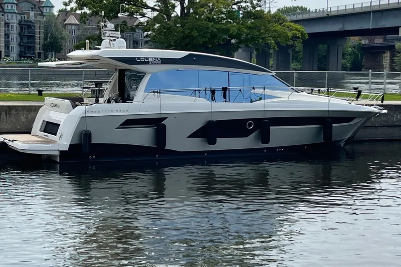  Yacht Photos Pics 2018 Prestige 520 yacht docked by a riverside, showcasing sleek design and modern features.