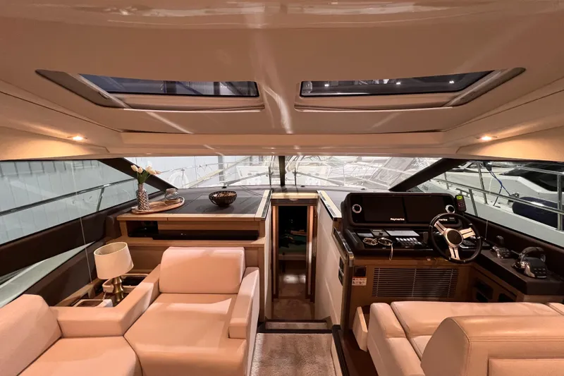  Yacht Photos Pics Luxurious interior of a 2018 Prestige 520 yacht with modern helm and seating area.
