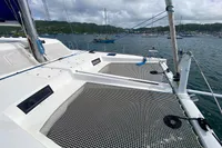 Nautitech 542 catamaran deck with netting, anchored in a scenic bay, 2013 model.