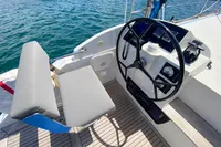 Helm of 2013 Nautitech 542 catamaran with steering wheel and navigation instruments.