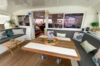 Luxurious Nautitech 542 yacht interior with cozy seating, decorative pillows, and elegant table setting.