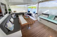 Luxurious Nautitech 542 yacht interior with elegant seating, table, and scenic ocean view.