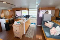 Luxurious interior of 2013 Nautitech 542 yacht with modern kitchen and cozy seating area.