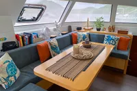 Cozy interior of 2013 Nautitech 542 yacht with decorative pillows and candles.