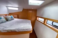 Cozy bedroom in 2013 Nautitech 542 yacht with ocean view and skylight.