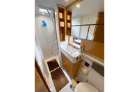 Luxurious bathroom in 2013 Nautitech 542 yacht, featuring modern fixtures and elegant wood accents.
