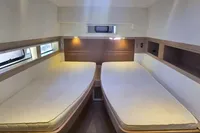 Interior cabin of 2013 Nautitech 542 catamaran with twin beds and modern design.