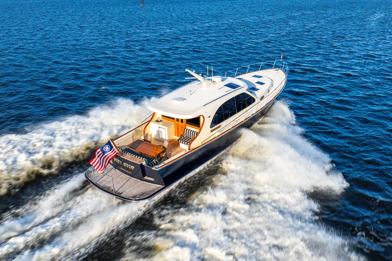 Pitt Stop Yacht Photos Pics 2020 Palm Beach Motor Yachts PB55 cruising on open water, rear view.